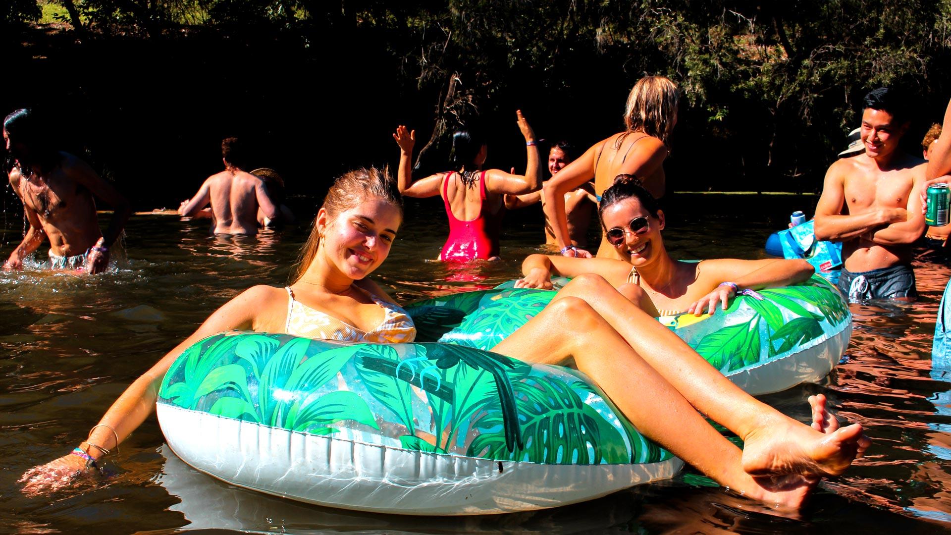 Jungle Love Festival girls sitting in inflatable tube on river