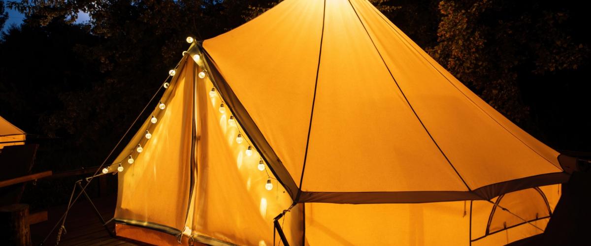 Bell Tent at night with festoon lights on front