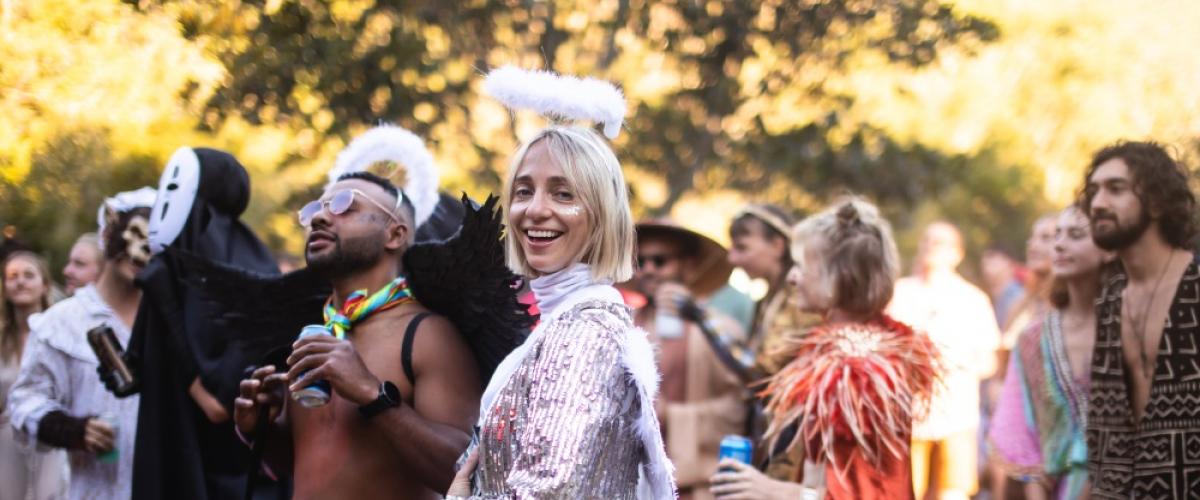 Party goers in fancy dress costume at the main stage in the day time